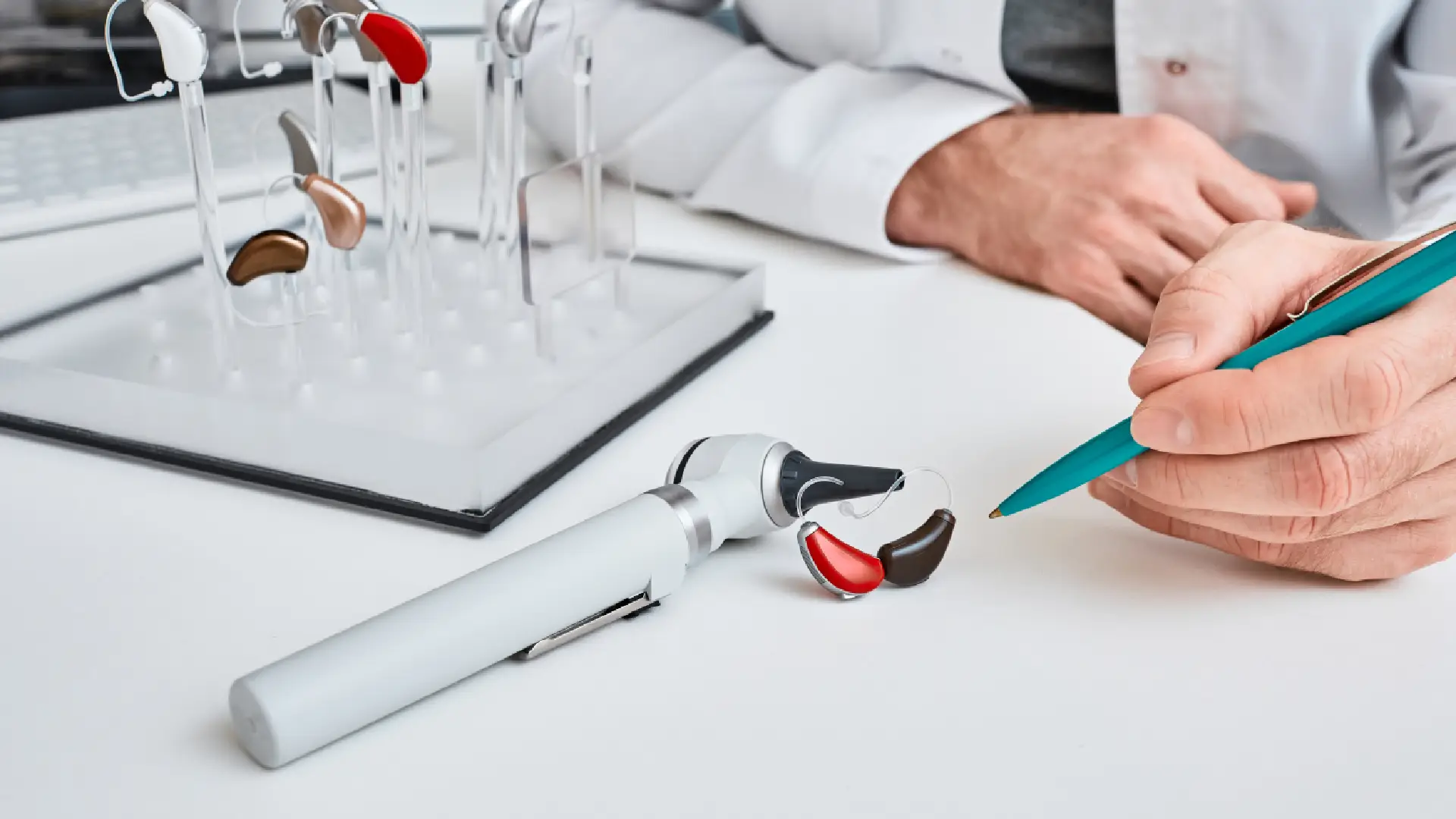 audiologist showing hearing aid